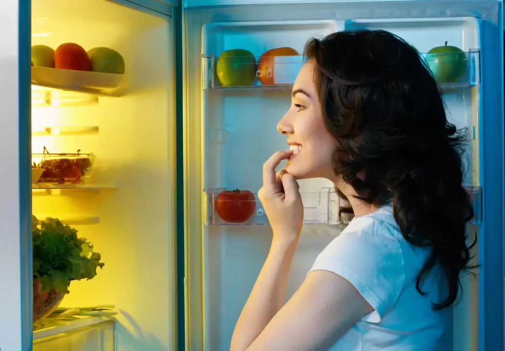 girl looks in the refrigerator during rapid weight loss